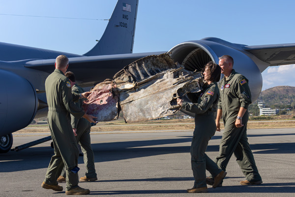 Wisconsin Air National Guard officers carry the P-38 “Marge” wingtip artifact aboard U.S. Air Force (USAF) KC-135R Stratotanker. Left: Colonel Christopher Triplett. Right Brigadier General Adria Zuccaro and Lieutenant Colonel Michael Dirnberger. CREDIT: PACIFIC WRECKS/RAINE FLYNN