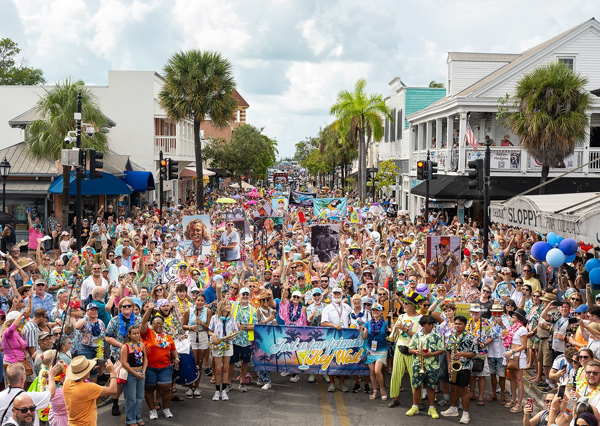 Fans of the late Jimmy Buffett parade along Duval Street in Key West, Fla., during the 2025 "Just a Few Friends" festival celebrating the famed singer-songwriter's life and legacy. The third annual festival is scheduled Sept. 3-7, 2026, on the island Buffett called home during some of his most productive years and featured in many of his enduring songs. (Photo credit: Nick Doll, Just a Few Friends)