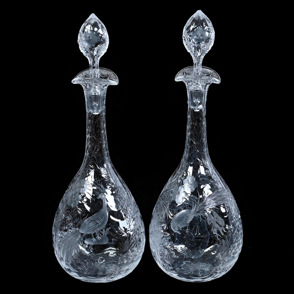 Lot #18 consists of two Brilliant Period Cut Glass (BPCG) rock crystal decanters, each one 14¾ inches tall and featuring a finely engraved tropical bird and floral design. Estimate: $750-$1,500