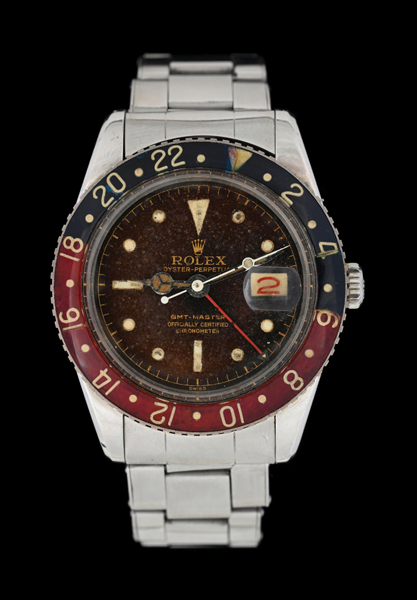 Rolex Oyster Perpetual Date 38mm GMT-Master wristwatch, Reference 6542, in all stainless steel with original red and blue Bakelite bezel insert, tropical black gilt dial. Estimate: $120,000-$180,000